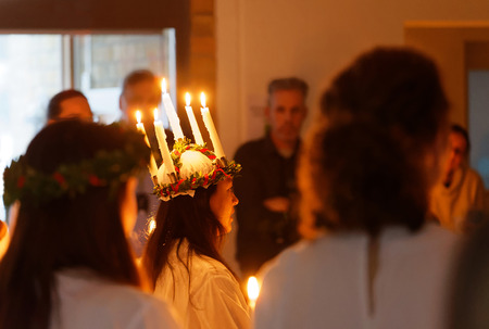 STOCKHOLM, SWEDEN - DEC 13, 2017: Lucia parade with singing girls and boys in white dresses holding candles. Traditional celebration of the suffering of saint Lucia from Italy in Stockholm Sweden, December 13, 2017のeditorial素材