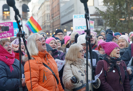 STOCKHOLM, SWEDEN - JAN 21, 2018: Singing crowd of senior people in the Womens March, a worldwide protest for women's rights in central Stockholm, Norrmalmstorg, Sweden, January 21, 2018のeditorial素材