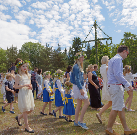 VADDO, SWEDEN - JUNE 23, 2017: CChildren and adults dancing around the Maypole celebrating the Swedish Midsummer. June 23, 2017のeditorial素材