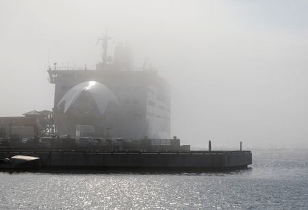GRISSLEHAMN, SWEDEN - JUL 12, 2017: Cars driving of a car ferry a foggy day. Grisslehamn Sweden, July 12, 2017のeditorial素材