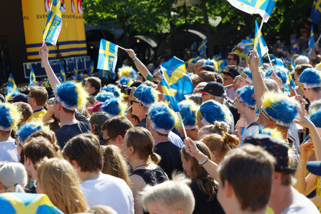 STOCKHOLM, SWEDEN - MAY 21, 2018: People waving Swedish flags to celebrate the swedish ice hockey players winning the World Championship 2018. In Kungstradgarden, Stockholm, Sweden, May 21, 2018のeditorial素材