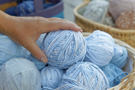 Womans hand holding a blue ball of matte crumbleの写真素材