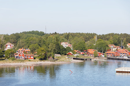 GRISSLEHAMN, SWEDEN - JUL 13, 2018: Harbor in the rural village Grisslehamn on the east cost of Sweden. Typical red and white traditional wooden houses. July 13, 2018のeditorial素材