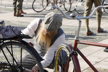STOCKHOLM - SEPT 22, 2018: People wearing old fashioned clothes from the 1950s preparing their retro bicycles in the Bike in Tweed event September 22, 2018 in Stockholm, Swedenのeditorial素材