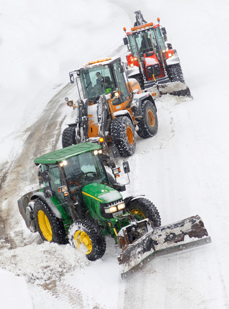 STOCKHOLM, SWEDEN - FEB 03, 2019: Snow chaos and many tractors equipped with ploughs on the streets of Stockholm, February 03, 2019 in Stockholm, Swedenのeditorial素材