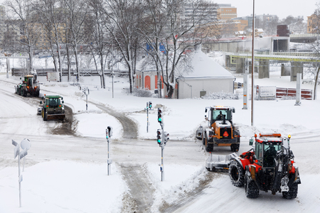 STOCKHOLM, SWEDEN - FEB 03, 2019: Snow clearance using tractors equipped with ploughs on the streets of Stockholm, February 03, 2019 in Stockholm, Swedenのeditorial素材