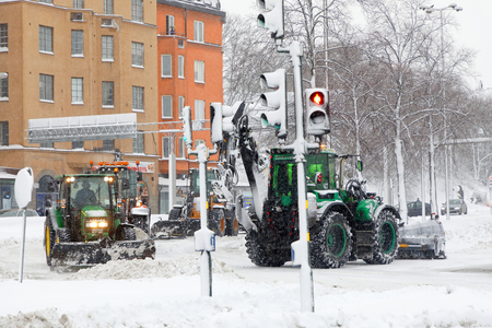 STOCKHOLM, SWEDEN - FEB 03, 2019: Snow chaos and many tractors equipped with ploughs on the streets of Stockholm, February 03, 2019 in Stockholm, Swedenのeditorial素材