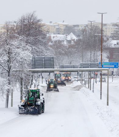 STOCKHOLM, SWEDEN - FEB 03, 2019: Snow chaos and many tractors equipped with ploughs on the streets of Stockholm, February 03, 2019 in Stockholm, Swedenのeditorial素材