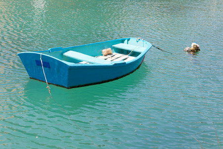Colorful blue traditional fishing boats in the green water in the harbor in Malta, Valettaの写真素材