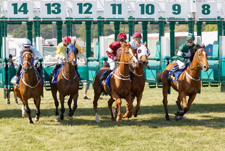 STOCKHOLM, SWEDEN - JUNE 06, 2019: Start of the gallop race for arabian  race horses and colorful jockeys at ATG Nationaldags Galoppen at Gardet. June 6, 2019 in Stockholm, Swedenのeditorial素材