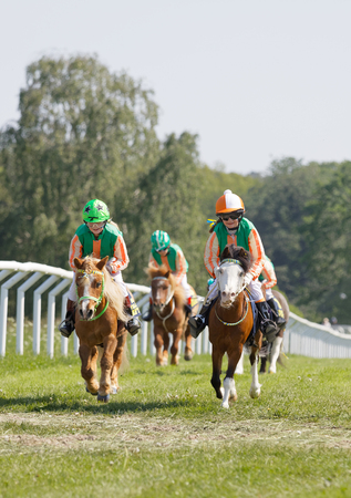 STOCKHOLM, SWEDEN - JUNE 06, 2019: Many young jockey girls riding cute ponys at Nationaldags Galoppen at Gardet. June 6, 2019 in Stockholm, Swedenのeditorial素材