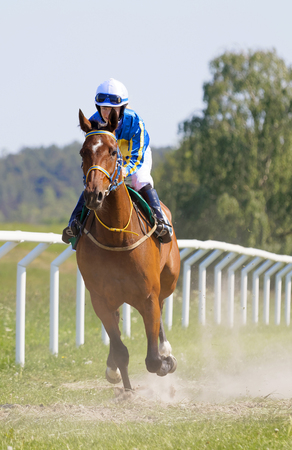 STOCKHOLM, SWEDEN - JUNE 06, 2019: Female jockey riding a arabian gallop race horse at the race track at ATG Nationaldags Galoppen at Gardet. June 6, 2019 in Stockholm, Swedenのeditorial素材