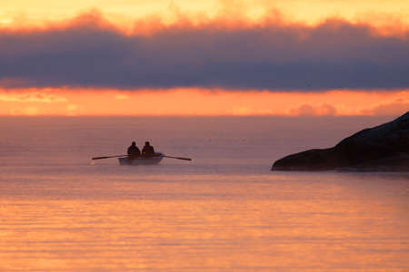 GRISSLEHAMN, SWEDEN - DEC 18, 2020
Two men in a row boat during sunrise, the light is orange.
Grisslehamn, Sweden December 18, 2020のeditorial素材