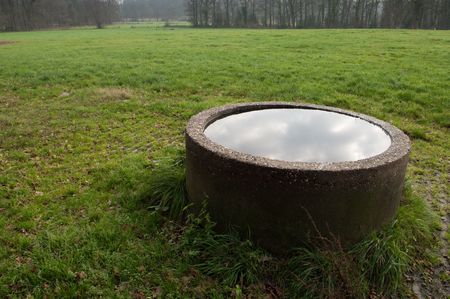 stone well top filled with waterの写真素材