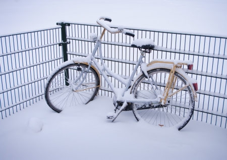 abandoned bicycle covered with snowの写真素材