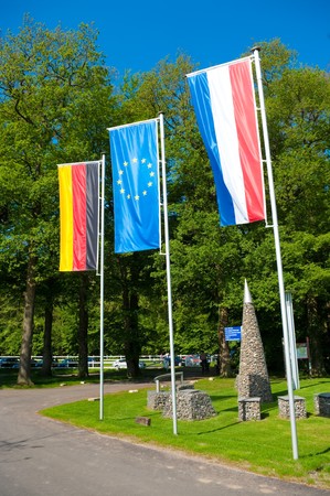 german and dutch flag with in the middle the blue european union flagの写真素材