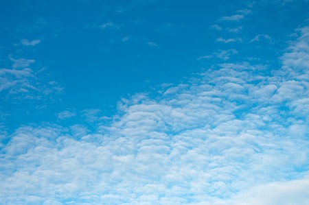 clear blue sky with small white cloudsの写真素材