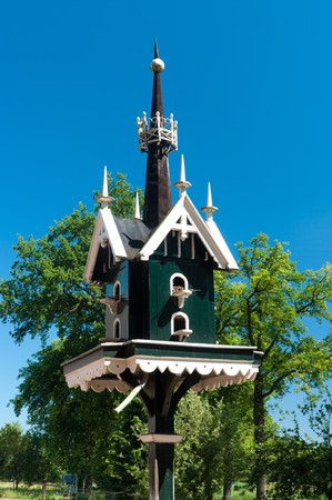 green with white painted birdhouse for dovesの写真素材