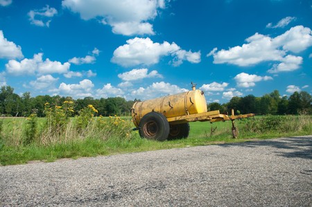 yellow water tank used to supply extra water for cattle when its too hotの写真素材