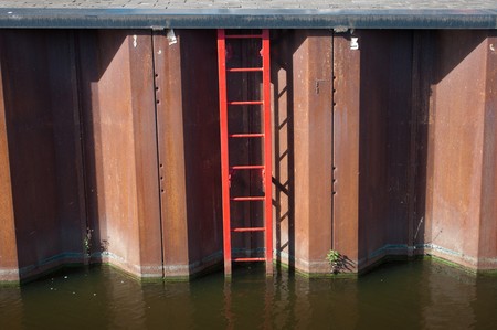 red stairs leading into the waterの写真素材