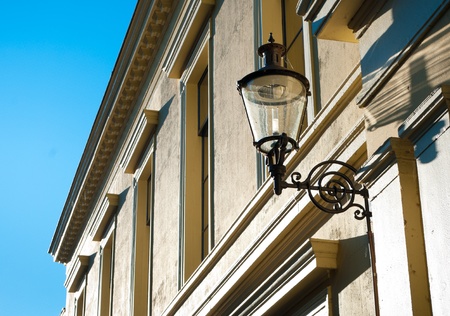old lantern at the facade of a monumental buildingの写真素材