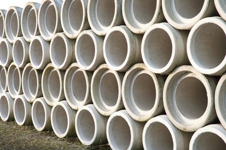 concrete drainage pipes stacked on a construction siteの写真素材