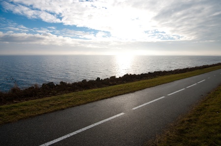 empty bicycle path along a lakeの写真素材