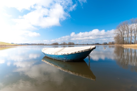 rowing boat floating on a small lake in the Ooijpolder near Nijmegenの写真素材