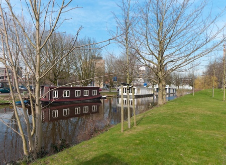 houseboats in a canal in Leiden, Netherlandsの写真素材