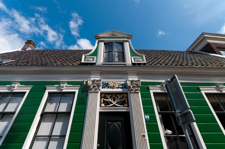 facade of a beautiful wooden house against a blue sky in Zaanse Schans, netherlandsのeditorial素材