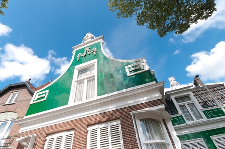facade of a beautiful wooden house against a blue sky in Zaanse Schans, netherlandsのeditorial素材