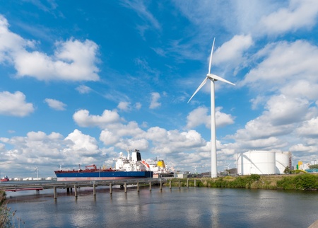 chemical tankers moored in amsterdam harbor next to a large windturbine