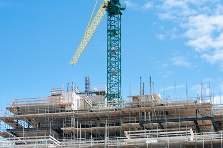 large crane above a not yet finished buildingの写真素材