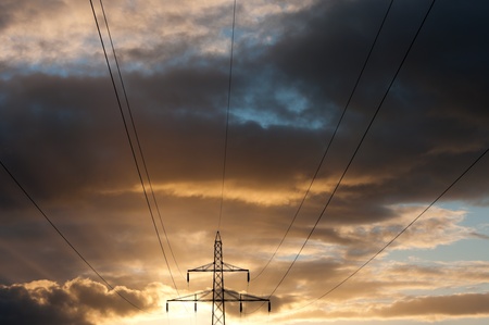 electricity pylons against a nice yellow orange sunset
