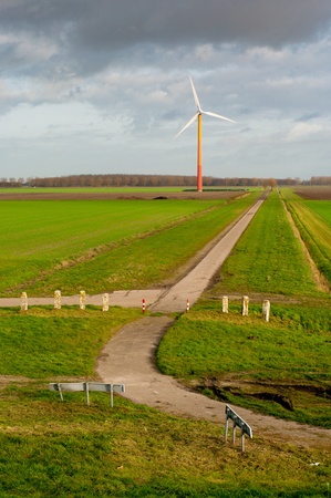 colorful windmill at the end of a small road in Almere, Netherlandsの写真素材