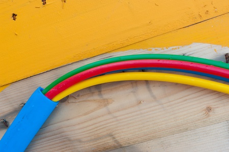 cable on cable drum containing four cables in different colorsの写真素材