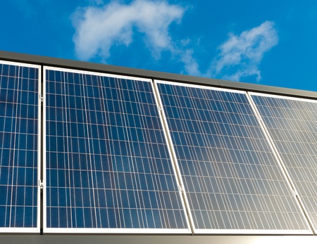 solar panels against a blue sunny skyの写真素材