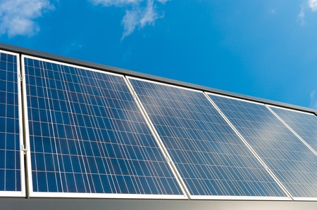 solar panels against a blue sunny skyの写真素材