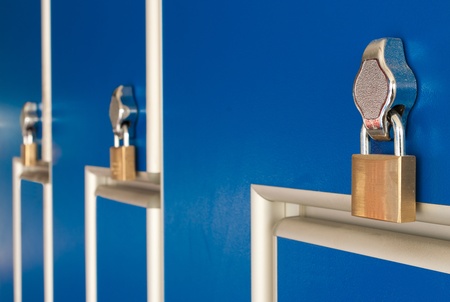 safety locks on blue industrial metal lockersの写真素材
