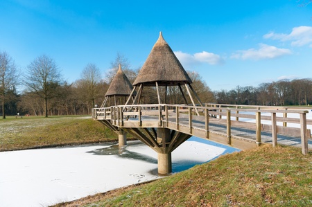 typical footbridge over a frozen canalの写真素材