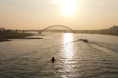 arch bridge over the Waal river at Nijmegen, netherlandsの写真素材