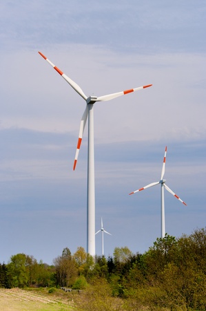 several windmills against a blue sky