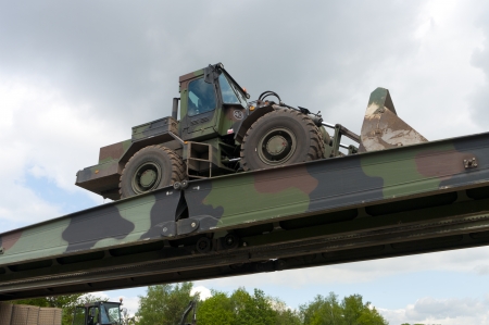 military vehicle crossing a military removable bridge