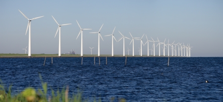 row of windturbines along the IJsselmeer in the Netherlandsの写真素材