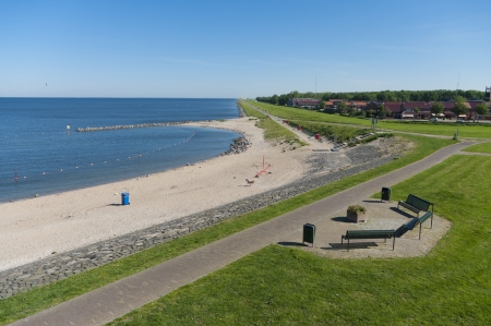 view over a small beach along the IJsselmeer in the Netherlandsの写真素材