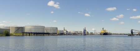 panoramic view of tanker and oil storage tanks in amsterdam harbor