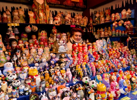 woman hidden between russian dolls in a stand at the christmas market in cologne, germanyのeditorial素材