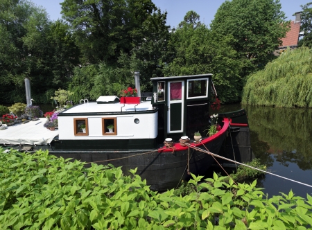 old barge in a canal in zwolle, netherlands, now in use as a home