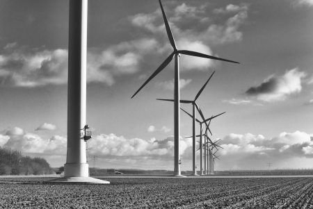 row of windmills in an agricultural landscape in the netherlandsの写真素材