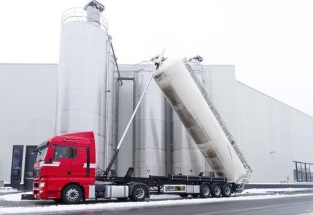 tanker truck refilling some large silos for food industryのeditorial素材